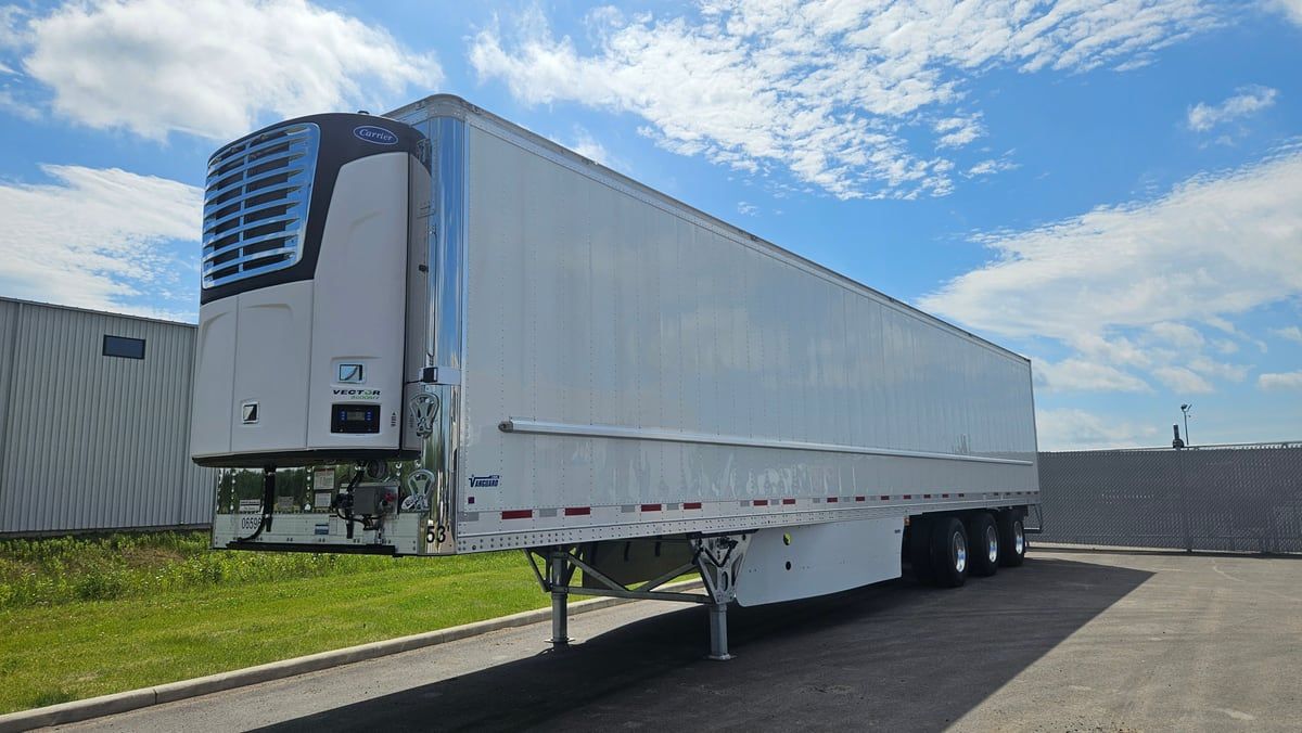 White 53-foot reefer trailer with refrigeration unit parked in a yard