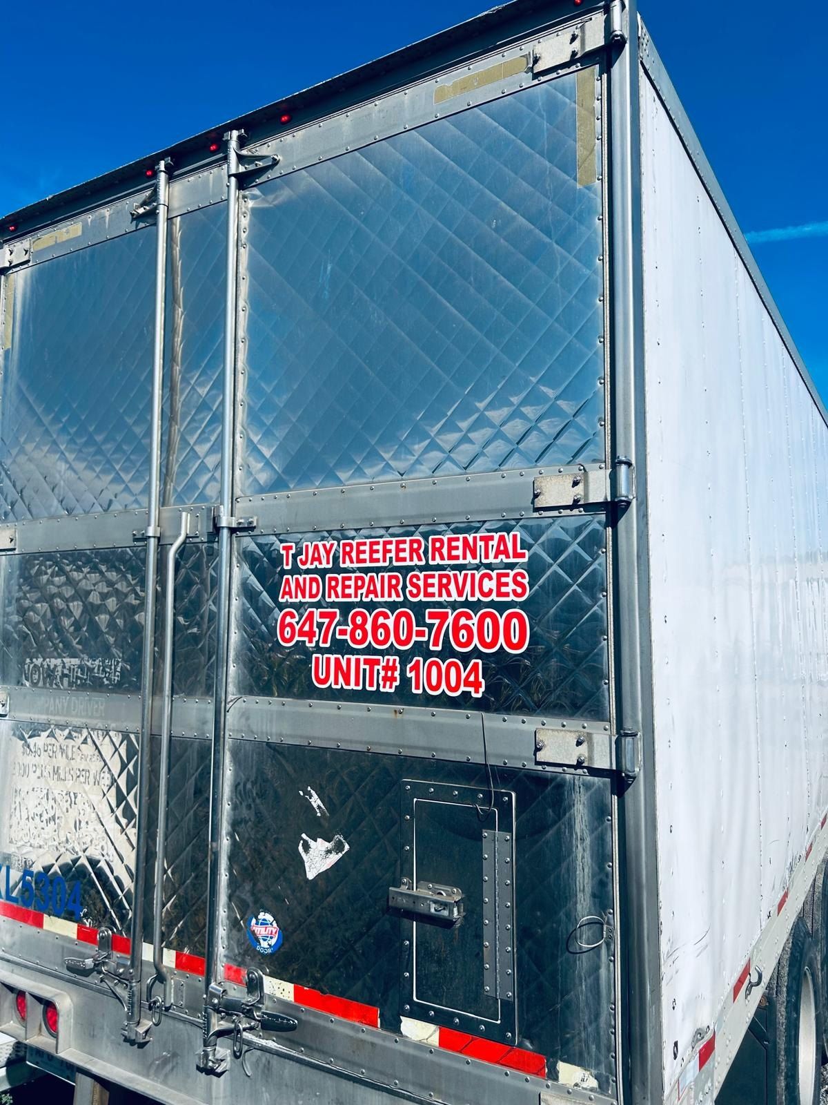 Rear doors of a reefer trailer lettered for reefer rental and repair services