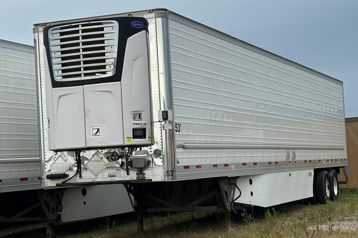 A white reefer trailer parked in our yard